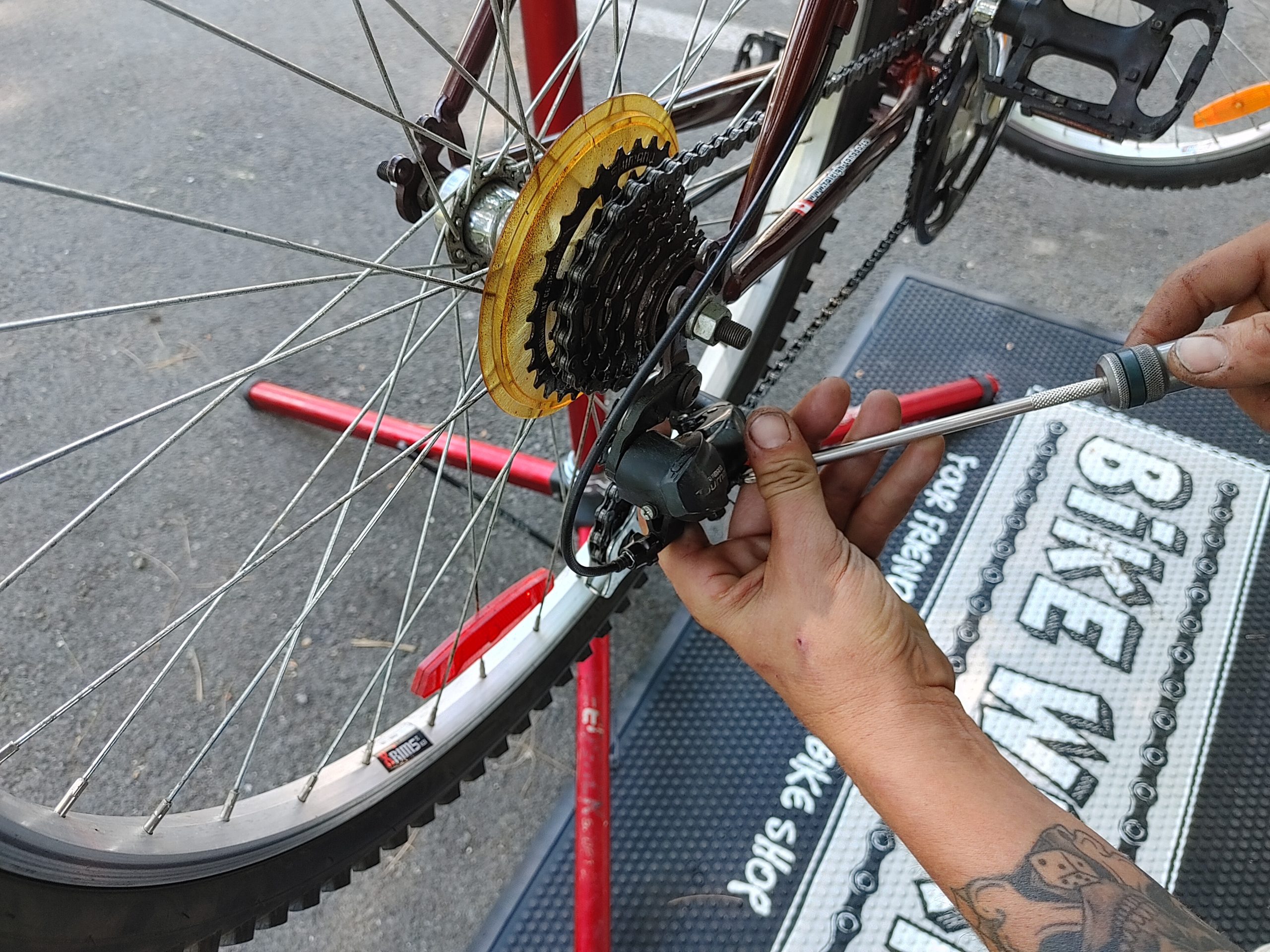 A Hand tuning up the Mountain Bike